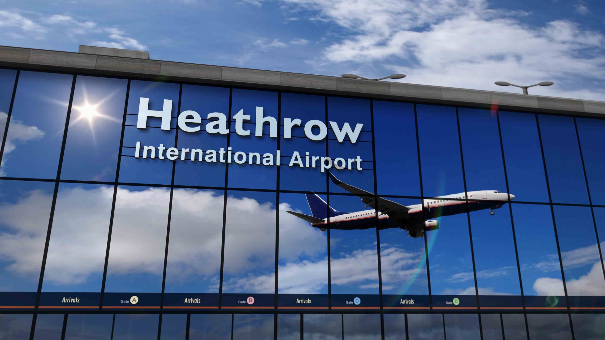 Imagem apresenta edifício do aeroporto de Heathrow, com janelas espelhadas e reflexo de avião levantando voo. Heathrow incentiva a utilização de SAF como combustível para a aviação.
